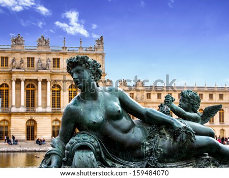 bronze sculpture in the garden of Versailles palace near Paris, France with blue sky (composition)