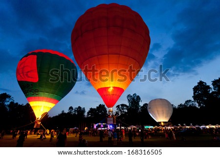 CHIANGMAI, THAILAND-DECEMBER 7: People watch the Hot air balloons flying at Thailand International Balloon Festival in Chiang Mai on December 7, 2013 in Chiangmai,Thailand