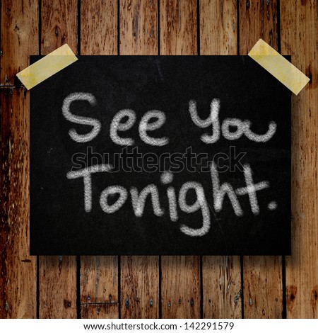 See you tonight note on message note with wooden background