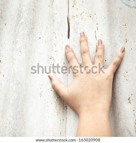 Right hand calling for help on grunge background
