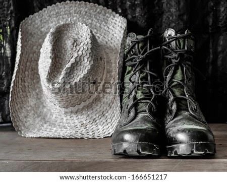 Old jungle boot and straw hat
