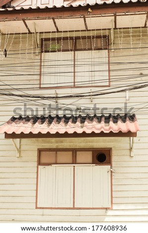 Old Thai style house with wires.