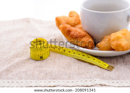 Deep fried dough stick and coffee, health concept
