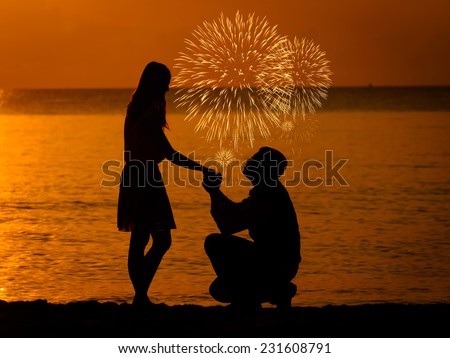 Man knees ask woman to marry with firework.