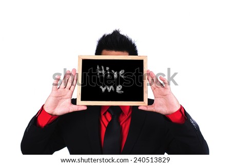 Businessman standing and holding black board with hire me message