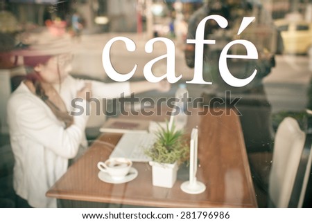 Cafe with Asian woman drinking coffee background.