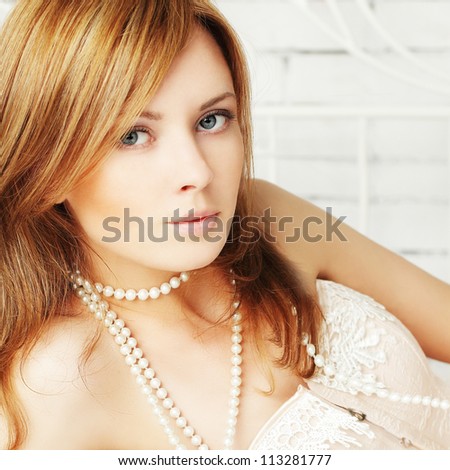 Beautiful sensuality woman with roses and pearls, seduction