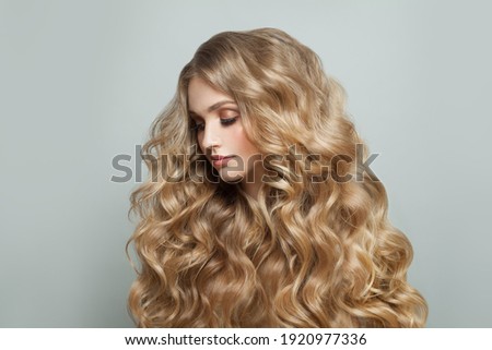 Blonde woman with long healthy hair, haircare concept