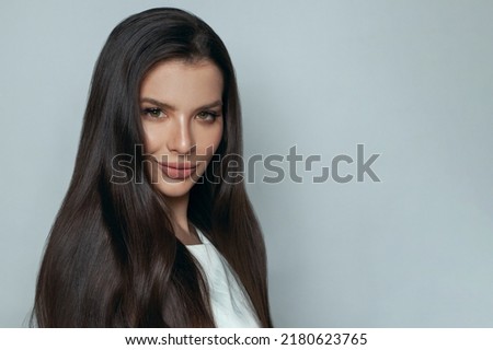 Similar – Image, Stock Photo Gorgeous dark-haired young woman stands with big eyes and demanding look in an old willow tree with fine shoulders