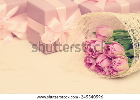 Holiday background with flowers, gift box and silky ribbon