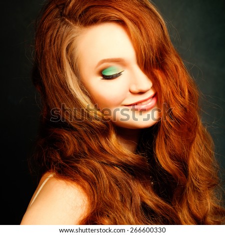 Long Curly Red Hair. Fashion Woman Portrait. Beauty Model Girl with Wavy Hair