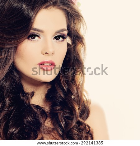 Beauty Face. Beautiful Brunette Woman with Makeup and Curly Hairstyle