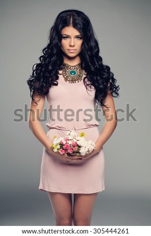 Fashion Model Girl in Little Pink Dress. Brunette Woman with Curly Dark Hair