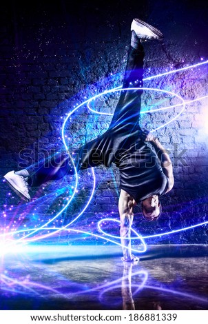 Young strong man break dance. With light effects.