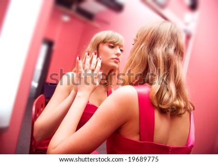 Woman beauty. Young woman in front of mirror in make-up room.