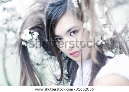Young woman with cherry flowers portrait. Original hair style.