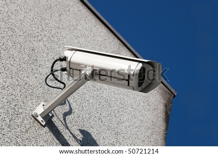 Security video camera on a wall.