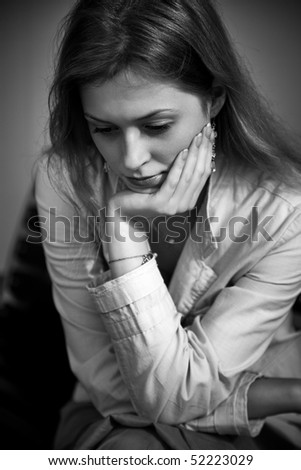 Thoughtful and sad woman portrait. Black and white.