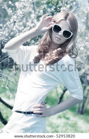Young woman with cherry flowers. Birght white colors.