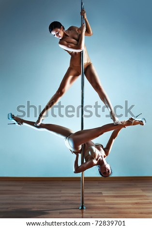 Two young sexy pole dance women.