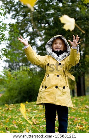 Girl throws up yellow maple leaves