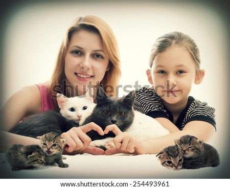 Girl hugging cats and show hands heart