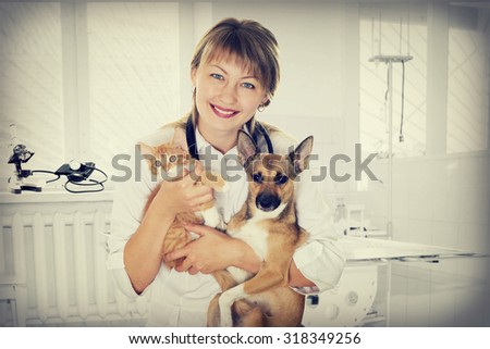 smiling vet and puppy and kitten in clinic, instagram