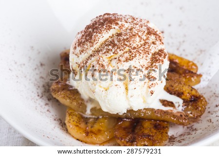 pan fried banana topped with vanilla ice cream and cocoa powder