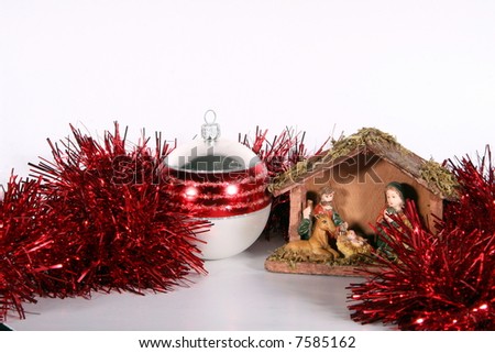 Glitter Ball And Stable A red glitter ball with a crib symbolizing Christmas. Isolated over white space (for text).