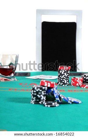 Ready To Play A poker table with chips a drink and cards. A chair invites to sit down. Isolated over white.