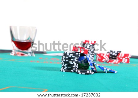 Poker Table With Liquor And Chips A poker table with chips a drink and cards. Isolated over white.