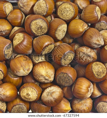 large dark hazelnuts. Background for food poster