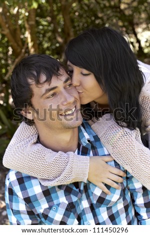 Attractive young man gets a kiss from beautiful young lady