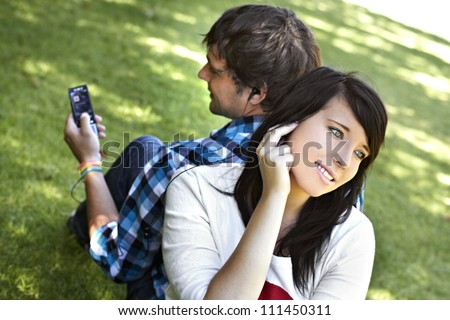 Romantic young couple sharing and listening to music