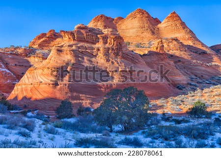 AZ-S Coyote Buttes-Pawhole area. A hike through this area makes one become very aware of Mother Nature\'s beauty. Snow adds to the beauty of these orange/ red rock formations in  this desert landscape.