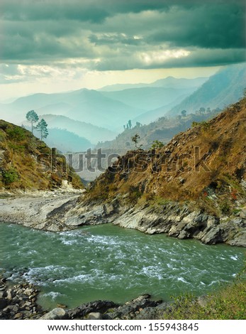 mountain river on the background of the misty mountain ranges of the Himalayas