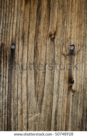 Striped dirty old burnt wooden background with nails