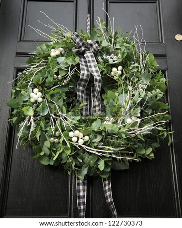Eucalyptus Christmas wreath hung on a black door