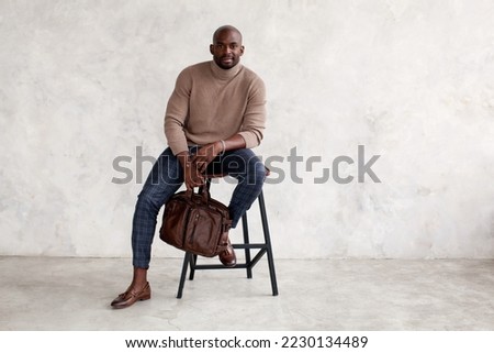 Similar – Image, Stock Photo Stylish man sitting at airport with suitcase and laptop, working, typing, browsing. Businessman traveling.