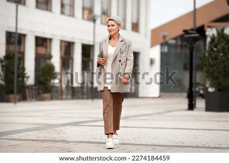 Similar – Image, Stock Photo Stylish woman in middle of city road