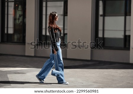 Similar – Image, Stock Photo Young brunette woman in the park exercising and stretching on a mat