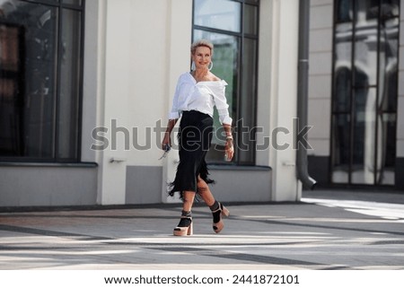 Similar – Image, Stock Photo woman on the street with an umbrella in rainy days