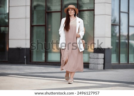 Similar – Image, Stock Photo Elegant woman in dress on brown background