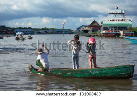 SIEM REAP, CAMBODIA SEPT 25: Cambodian people live on Tonle Sap Lake in Siem Reap, Cambodia on September 25, 2012. This is the largest freshwater lake in SE Asia peaking. Annual flooding of the village.