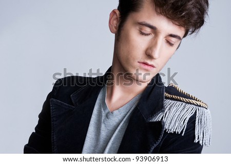 Fashion portrait of the young beautiful man  with eyes closed