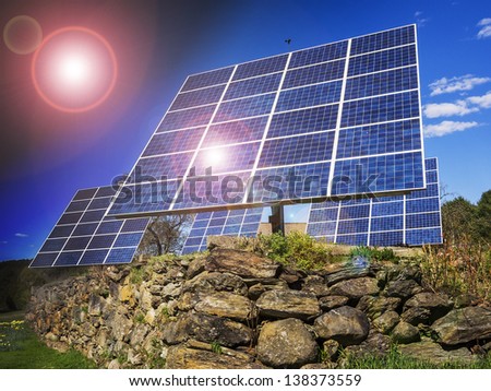 Solar panels in front of residential house with sun flare