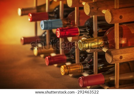 Wine bottles stacked on wooden racks shot with very limited depth of field