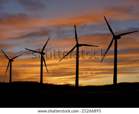 Wind farm silhouette under a setting sun