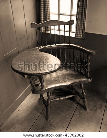 Old school desk in sepia located in 18th century colonial house