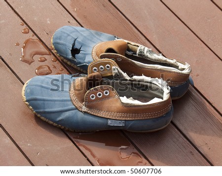Old rubber shoes on wet decking